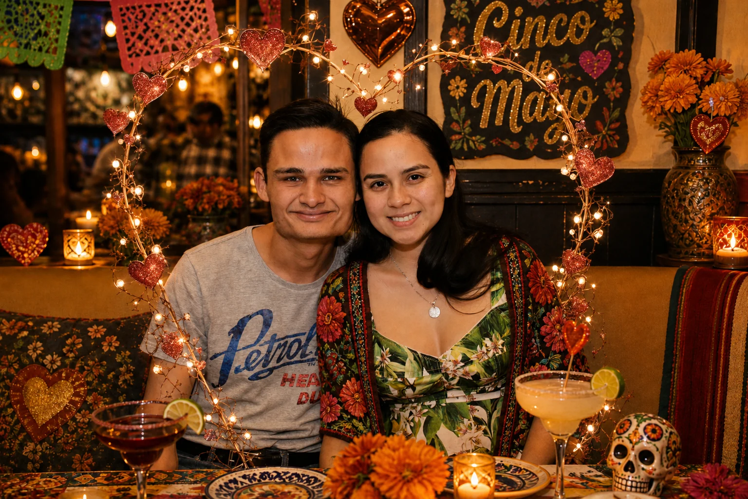 Two guests seated together behind orange flowers and a decorated skull at The Ox Tavern at Westwood