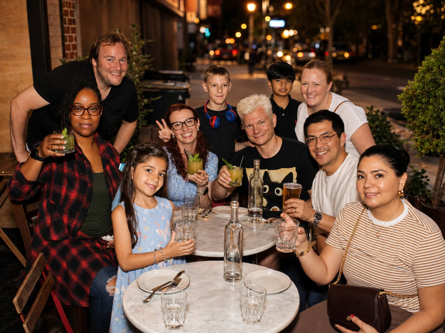 A group of adults and children gathered around a restaurant table at The Ox Tavern at Westwood